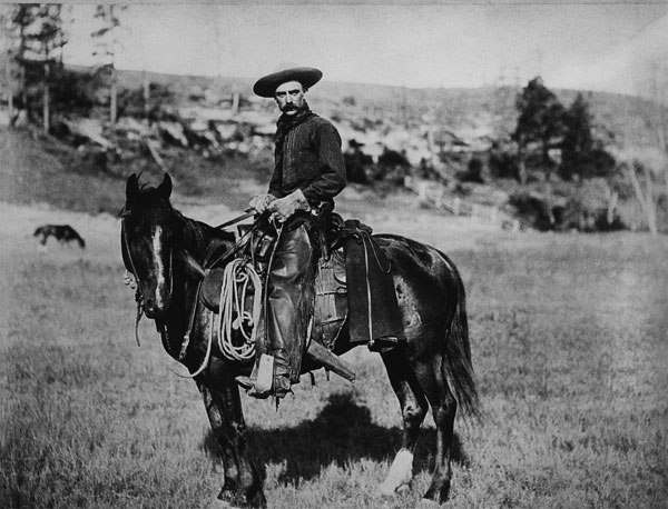 Cowboy riding a horse in Montana, USA, c. 1880 (b/w photo)  van American Photographer