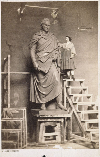 Harriet Hosmer on ladder with her sculpture of Thomas Hart Benton van American Photographer