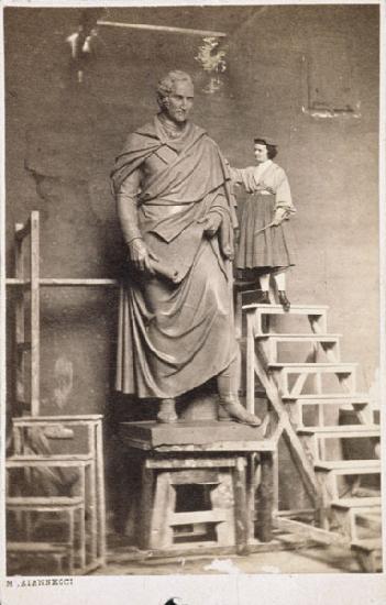 Harriet Hosmer on ladder with her sculpture of Thomas Hart Benton