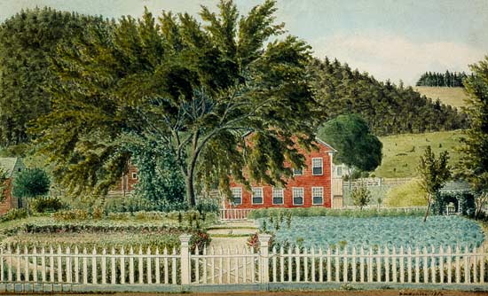 View of a Red House with a Picket Fence van American School