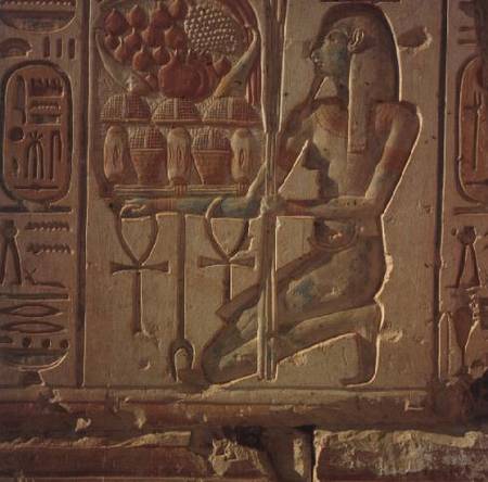 Kneeling figure presenting baskets of food, from the Temple of Ramesses II van Anoniem
