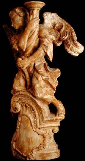 0ne of a pair of carved angel candlesticks