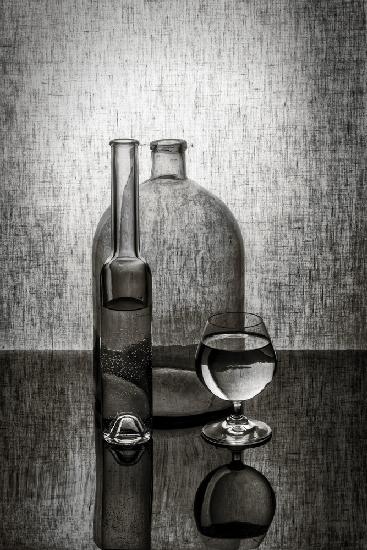 Still life with two bottles and a glass