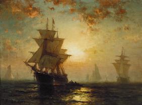 Zeilschepen bij zonsondergang