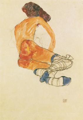 Sitzender weiblicher Akt mit blauem Strumpfband, vom Rücken gesehen