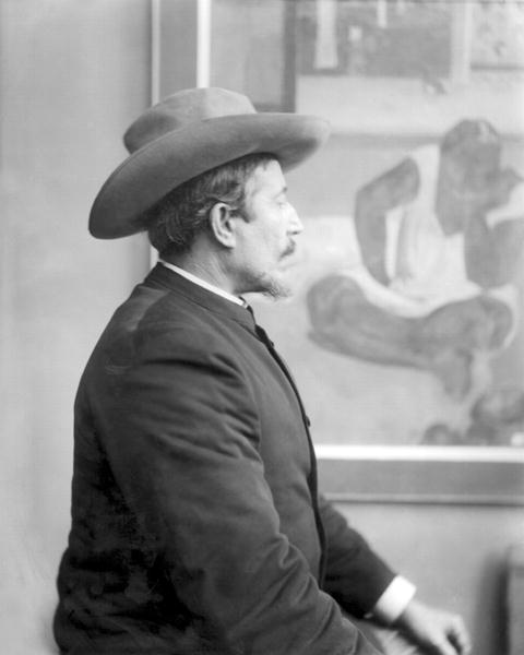 Paul Gauguin (1848-1903) in front of his canvases (b/w photo)  van French School