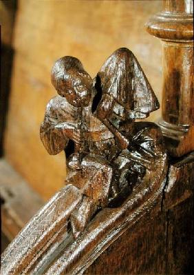 Musician playing a double flute, detail from a choir stall