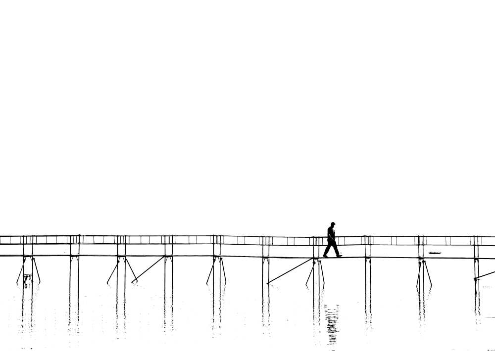 The lonely man on the plank bridge van Hans Peter Rank