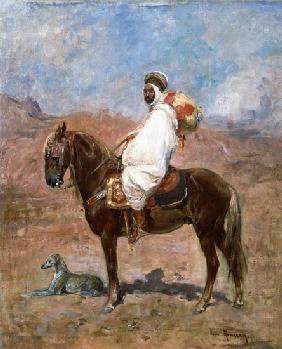 An Arab horseman in a desert landscape