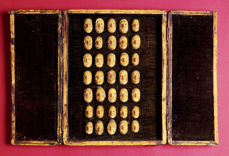 A Rare Set Of Thirty-Five Carved, Vegetable-Ivory Representations Of The Human Face, Depicting Vario van 