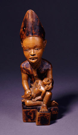 A Yombe Wood Carving Possibly Depicting A King Or Chief Presenting His Son van 