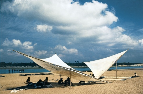Fishermen mending their nets under shade of triangular sails, Gopalpur (photo)  van 