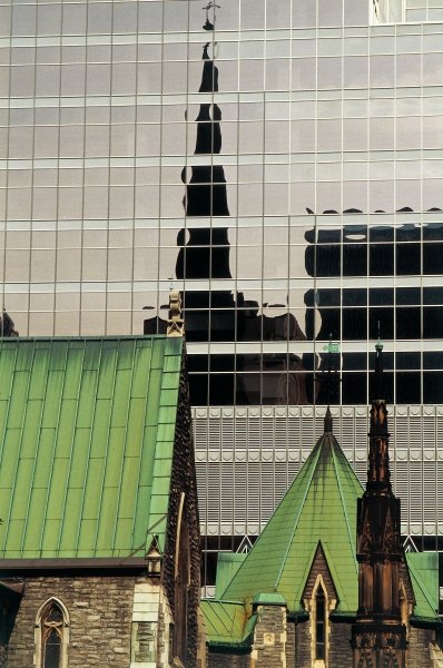 Green roofs and church reflected in glass panels (photo)  van 