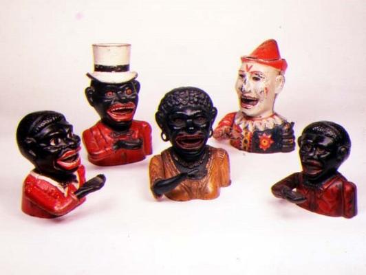 Group of Mechanical cast iron money banks. Left to right: Jolly Nigger with Butterfly Tie, Jolly Nig van 