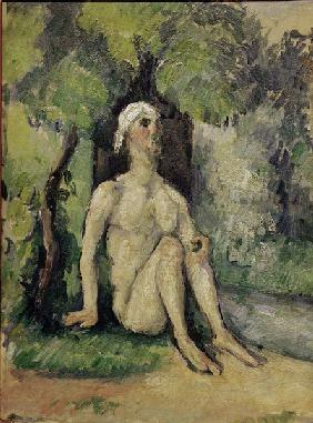 Bather sitting at waters edge