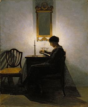 Woman reading by candlelight