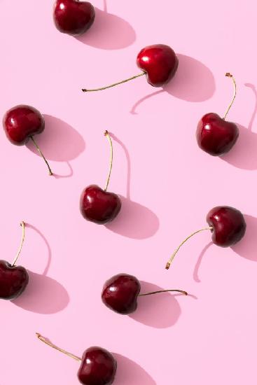 Cherries on pink background