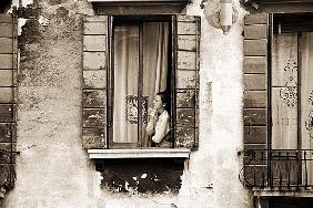 Woman gazing out of a window contemplating, 2004 (b/w photo) 