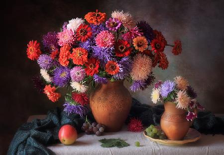With a bouquet of asters and zinnia